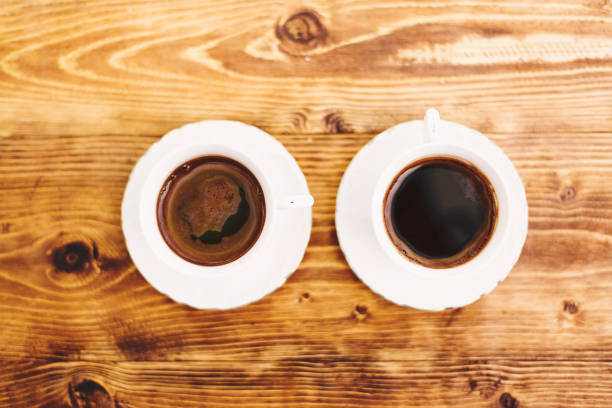 istock Two cups of coffee on wooden table, top view 1311158526