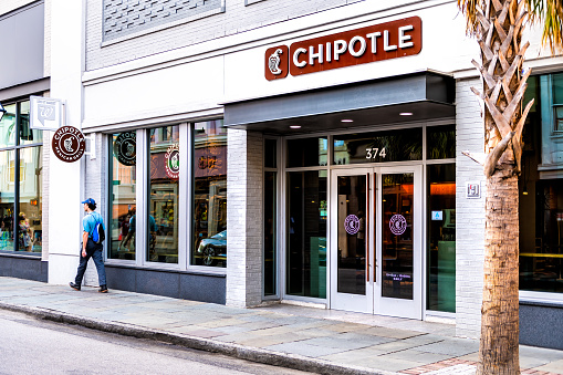 Charleston, USA - May 12, 2018: Chipotle restaurant sign in historic old town of South Carolina French quarter on King street with people