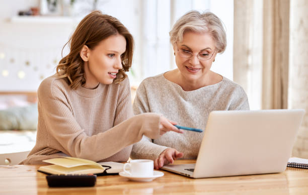 istock Young woman with mother using laptop while working on a remote p 1311161340