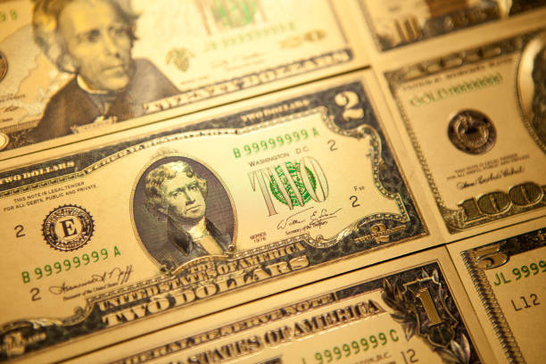 istock Currency US golden dollar banknotes close-up background. 1311161694