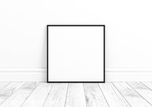 istock Single 10x10 Square Black Frame mockup on white wooden floor and white wall. 1311164464