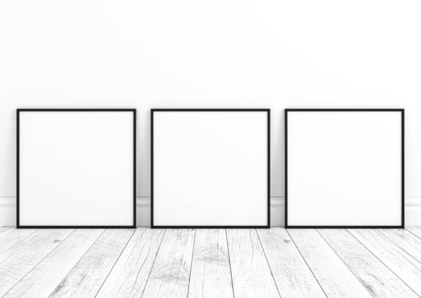 istock Triple 10x10 Square Black Frame mockup on white wooden floor and white wall. 1311164473