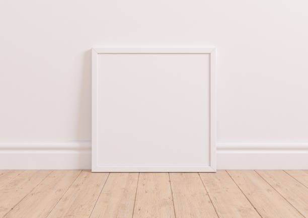 istock Single 10x10 Square white Frame mockup on wooden floor and white wall. 1311165487