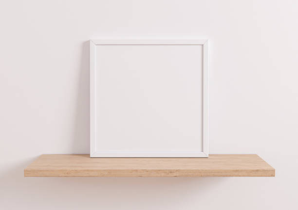 istock Single 10x10 Square white Frame mockup on wooden shelf and white wall. 1311165490
