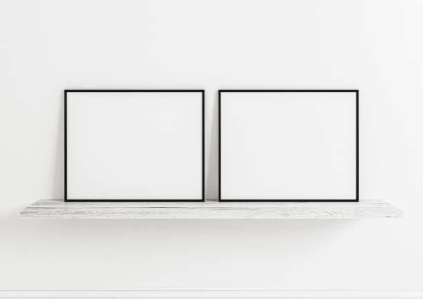 istock Double 8x10 Horizontal Black Frame mockup on white wooden shelf and white wall. 1311165660