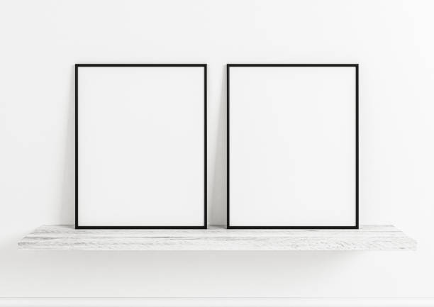 istock Double 8x10 Vertical Black Frame mockup on white wooden shelf and white wall. 1311165677