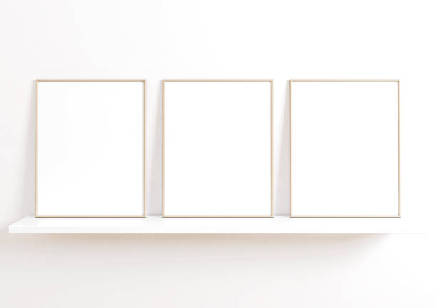 istock Triple 8x10 Vertical Beige Frame mockup on white shelf and white wall. 1311165793