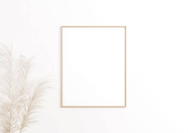 istock Single 8x10 Vertical Beige Frame mockup on white wall with boho leaves. 1311165800