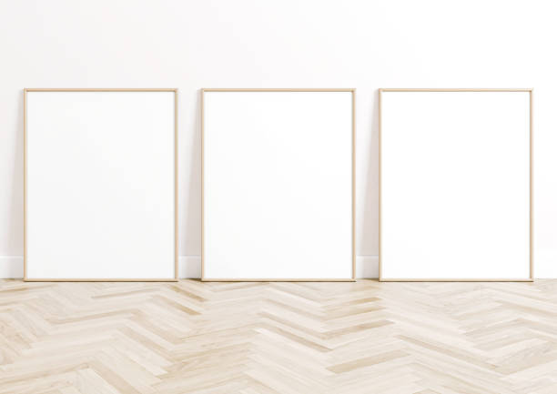 istock Triple 8x10 Vertical Beige Frame mockup on bright wooden floor and white wall. 1311165846