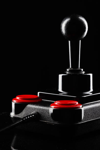 istock Retro joystick from 8-bit consoles. Game controller isolated on black background 1311166873