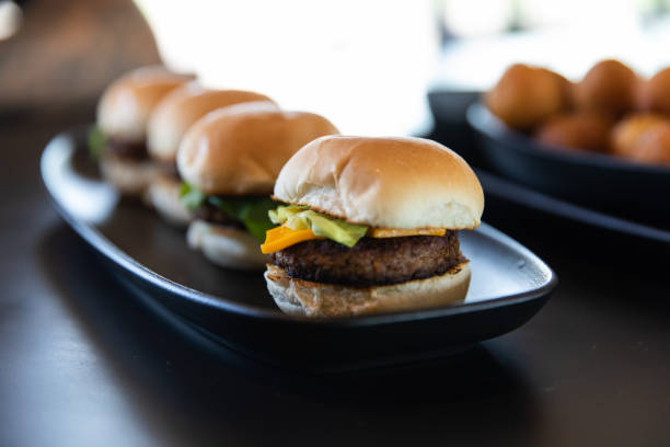 small hamburgers on a black plate