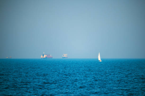 A windy day in English Bay with sailboats and freighters.