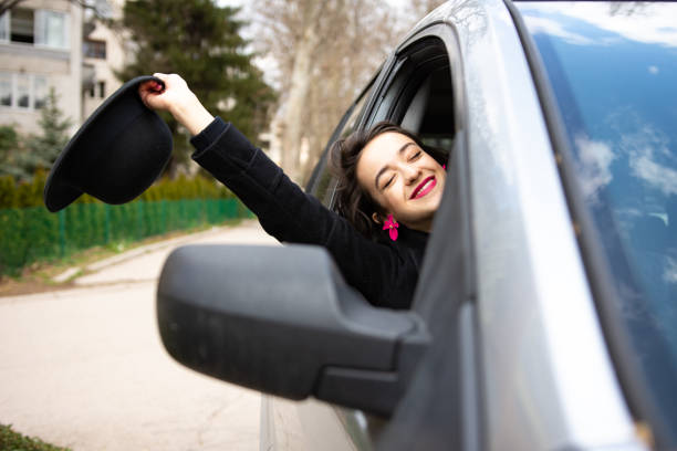istock Happy young woman having fun in car 1311167758