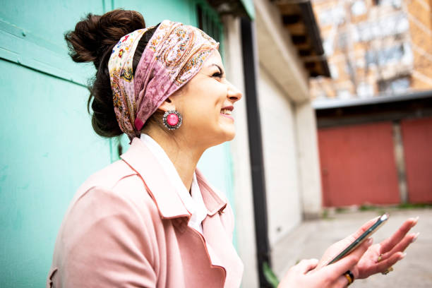 istock Beautiful young woman using smart phone 1311167799