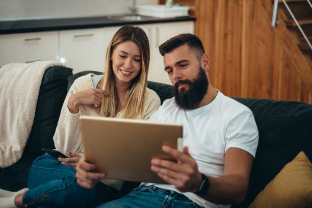 istock Couple using a digital tablet for a video call at home 1311167891