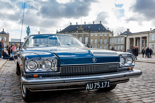 Copenhagen, Denmark - Oct 19, 2018: Close wide angle view of the front design of a Buick car parked along Frederiksgade Street. The Buick badge occupies a unique place in American automotive history.