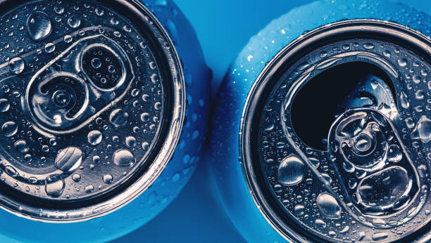 istock Two aluminum beer cans on blue background with water drops 1311172069