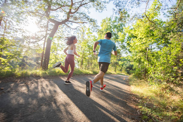 istock Two young athlete jogging in nature at sunny day. 1311172097