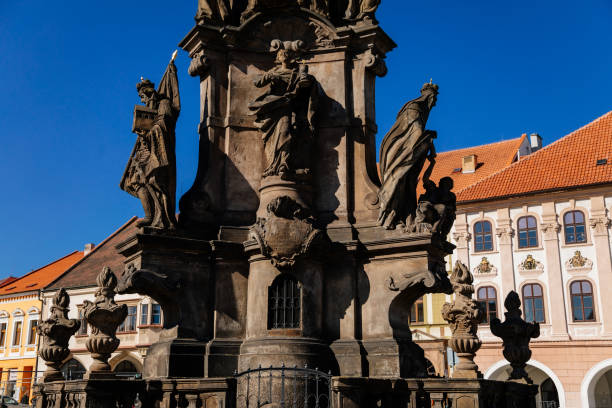 istock Holy Trinity Column with baroque sculptural group, Main town Peace square, Medieval narrow street, gothic and renaissance historical buildings, sunny day, Kadan, Czech Republic, April 04, 2021 1311174009