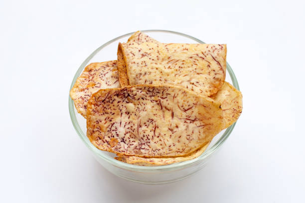 istock Crispy taro chips in glass bowl on white 1311175034