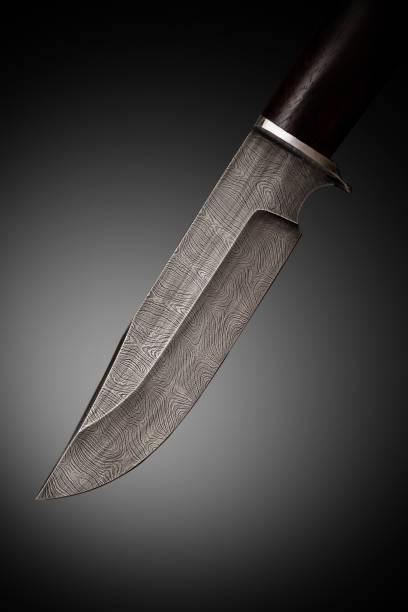 istock Knife of Damascus steel. Patterned blade close-up. 1311175090