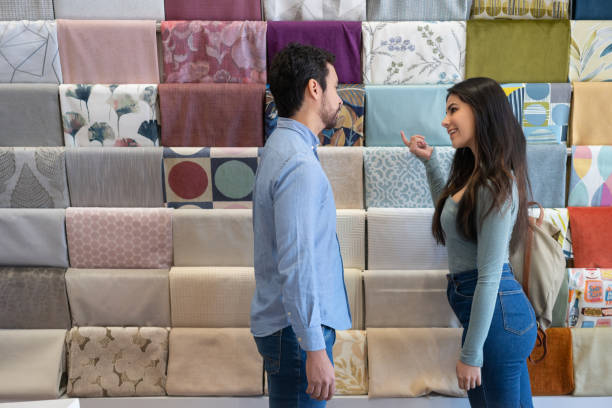 istock Young couple buying fabrics at a fabric shop 1311178401