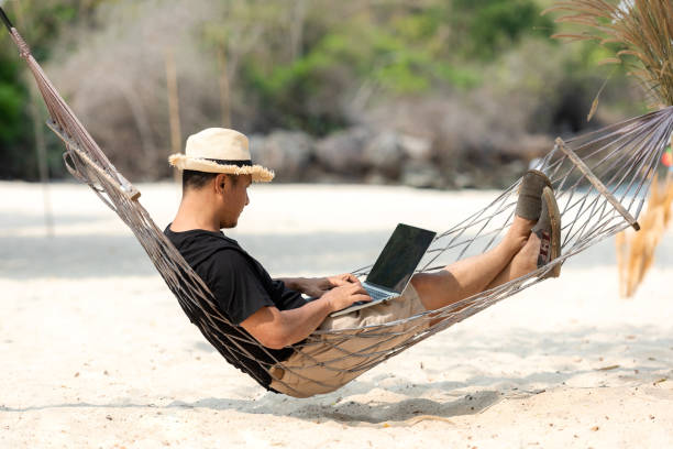 istock Lifestyle freelance man relax and sleeping on the hammock after using laptop working and relax on the beach. 1311181380