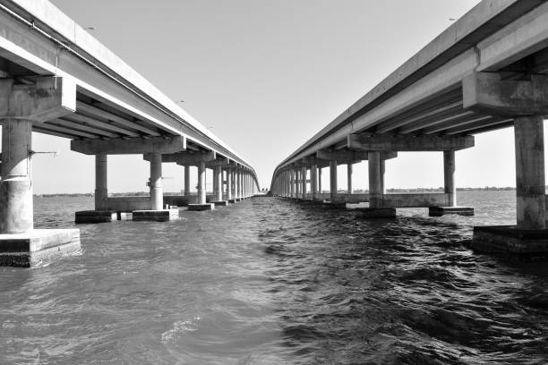 istock Black and White Causeway Bridge Over Water 1311181948