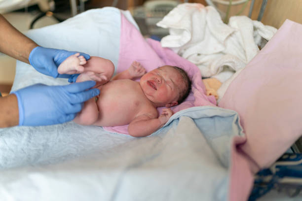 istock Newborn Baby Being Checked By Nurse After Delivery 1311182403