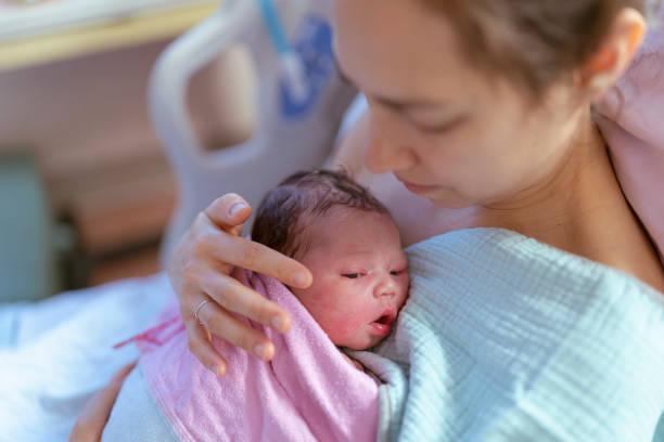 istock Mixed Race Mother Holding Newborn After Delivery 1311182432