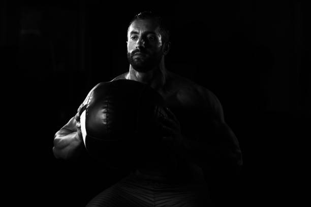 istock Muscular Man Exercise With Medicine Ball 1311186054