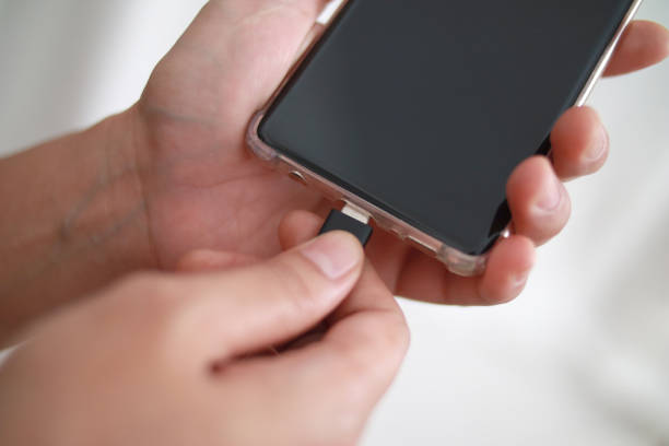 istock Plug in USB cord cable on smart phone, charging or and data transfer on mobile phone 1311186228