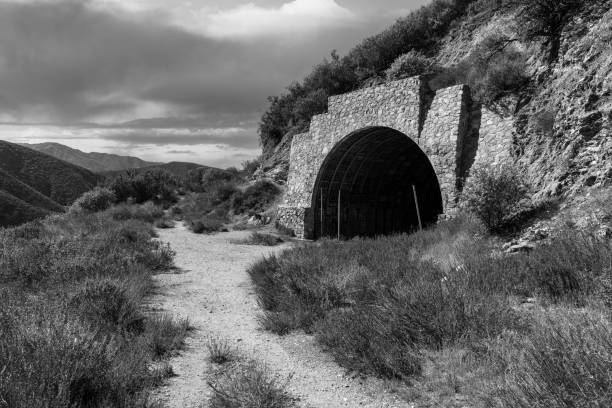 Black and white view of the tunnel to nowhere on Shoemaker Canyon Road in the San Gabriel National Monument above Los Angeles California.