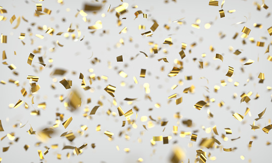 Shiny confetti with depth of field on light grey background