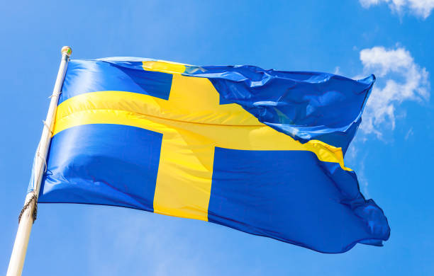 istock Swedish flag with yellow cross waving in the wind 1311190963