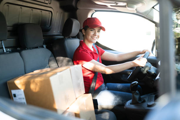 istock Smiling young woman working as a delivery driver 1311192233