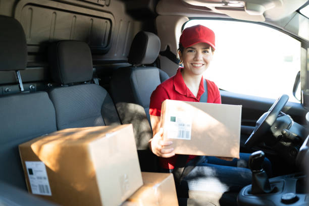istock Driver holding a package after arriving at a home shipping address 1311192239