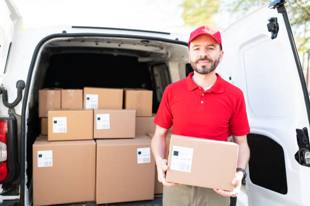 istock Hispanic man delivering a package in a delivery van 1311192266