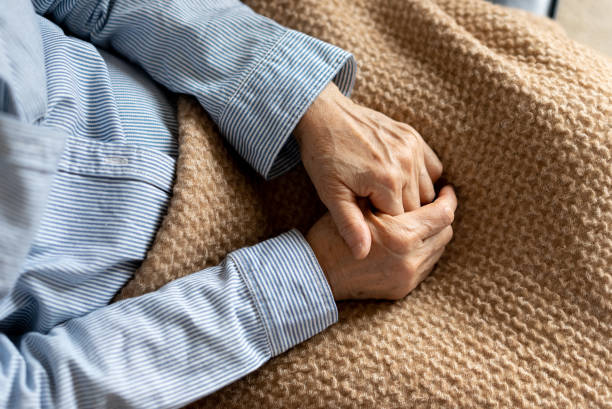 istock An elderly woman is sitting on the sofa at home 1311192321