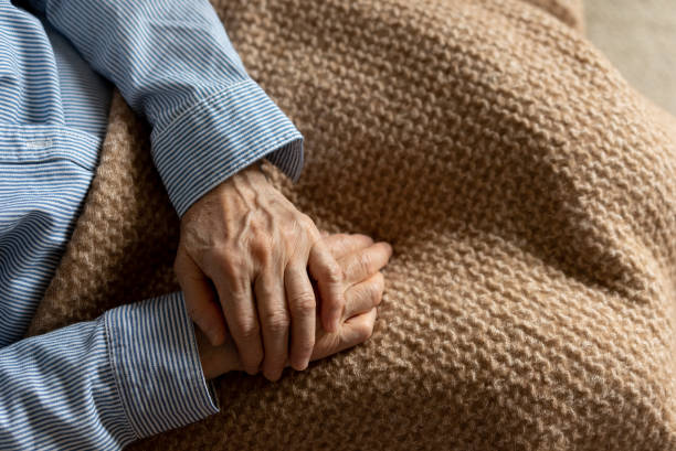 An elderly woman is sitting on the sofa at home An elderly woman is sitting on the sofa at home.
A quiet scene in the living room of a house, sitting on a sofa with a lap blanket.
Aging society. aging population stock pictures, royalty-free photos & images