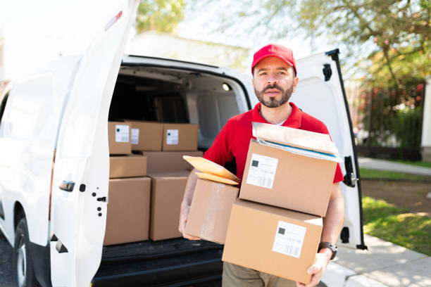 istock Latin courier and driver carrying a bunch of packages 1311192377