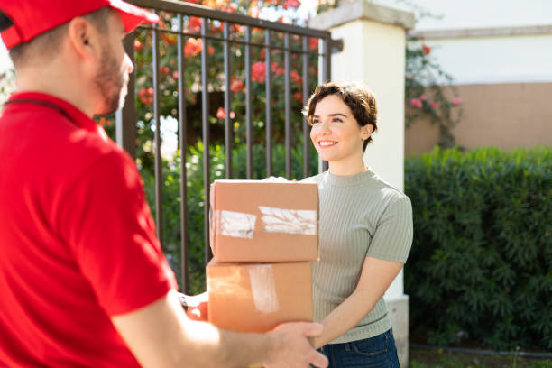 istock Delivery person delivering packages to a customer 1311192479