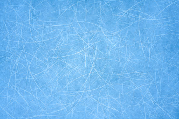 istock Ice blue background with ice skating tracks. Frozen water 1311195941
