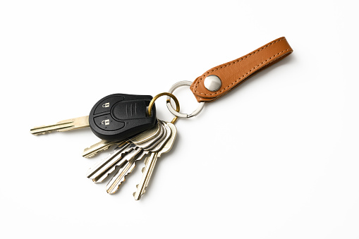 Bunch of Keys with leather key ring isolated on white with clipping path.