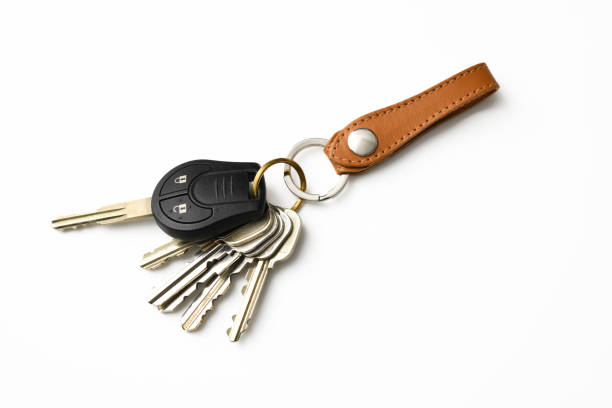 Bunch of keys with leather key ring on white background Bunch of Keys with leather key ring isolated on white with clipping path. key ring stock pictures, royalty-free photos & images