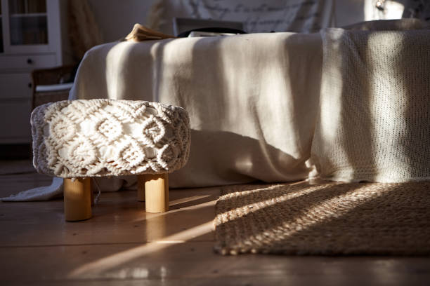 istock A small chair with a macrame-style seat. Bright bedroom in a modern style. 1311198656