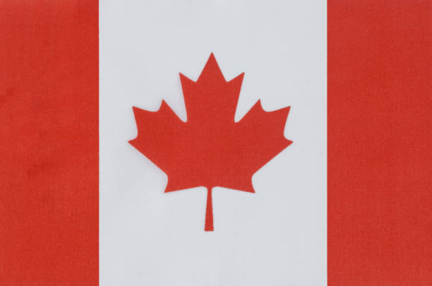 istock national flag of Canada on a fabric base close-up 1311199340