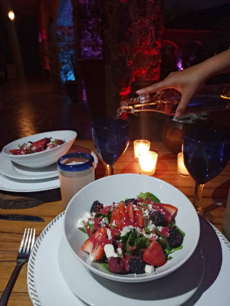istock romantic dinner by candlelight, vegetable salad and red fruits with white wine 1311200134
