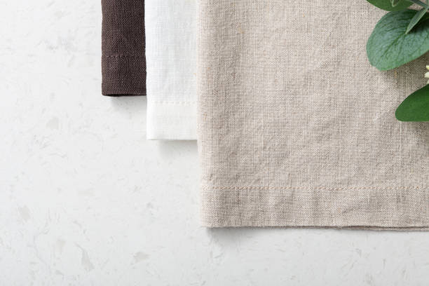 istock Linen napkin with green plant on marble table 1311201197