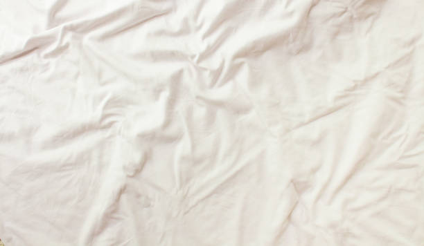 istock Flat layout white background. Modern minimal background with fabric texture and folds of cotton fabric. Top view 1311203938
